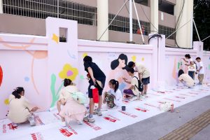 Students painting mural in school