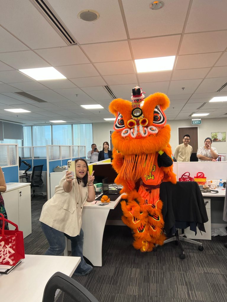 Nippon Paint staff enjoying the lion dance performance, a symbol of good luck for the New Year.