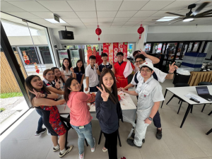 Nippon Paint Singapore colleagues taking part in the traditional Lo Hei toss for prosperity.