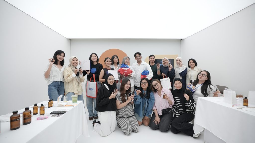 A group of people posing together at the Discover Colours 2026 exhibition space.