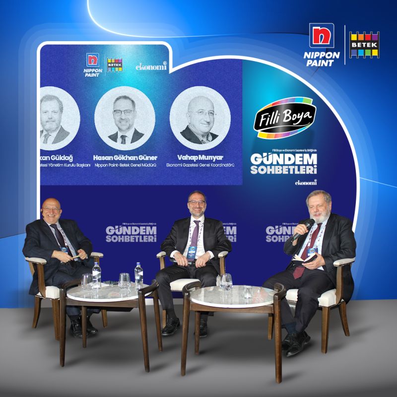 Three panelists, including Betek General Manager Hasan Gökhan Güner, seated on a stage during an event. 